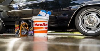 Car wash supplies in front of a shiny looking car.