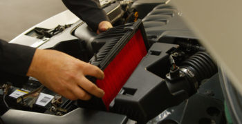 person showing how to install an new air filter