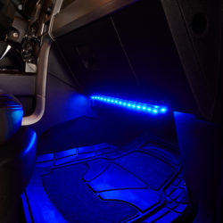 interior car led lights glowing under a glove box