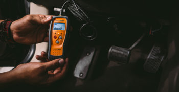 AutoZoner consulting his OBD reader and attempting to determine how to fix code P0011