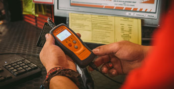 AutoZoner consulting his OBD reader and attempting to determine how to fix code p0136