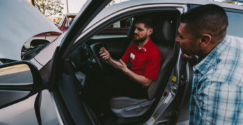 AutoZone asssociate showing a customer the Fix Finder scan tool with a P2509 reading