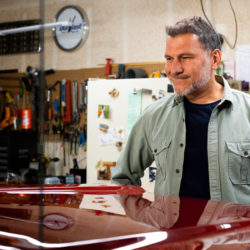 Man admiring his truck's hood after some paintless dent repair