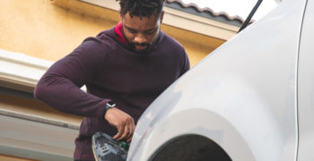 Man removing his headlight housing to get rid of headlight moisture