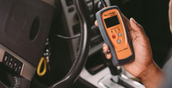 AutoZone associate using a code reader to diagnose P0441
