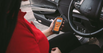 AutoZone associate using code reader to diagnose CEL P0446